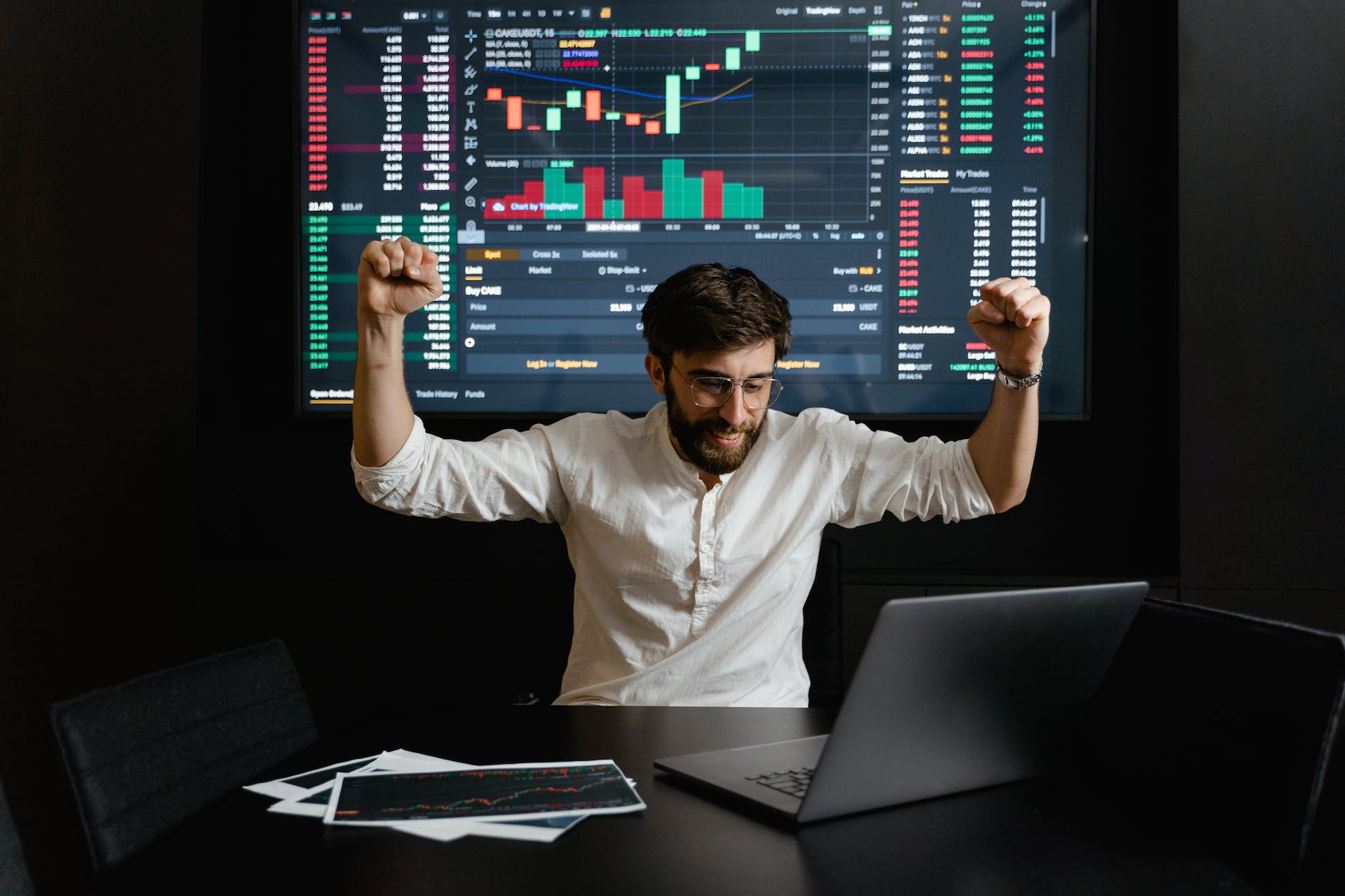 a businessman raising his hands for being successful