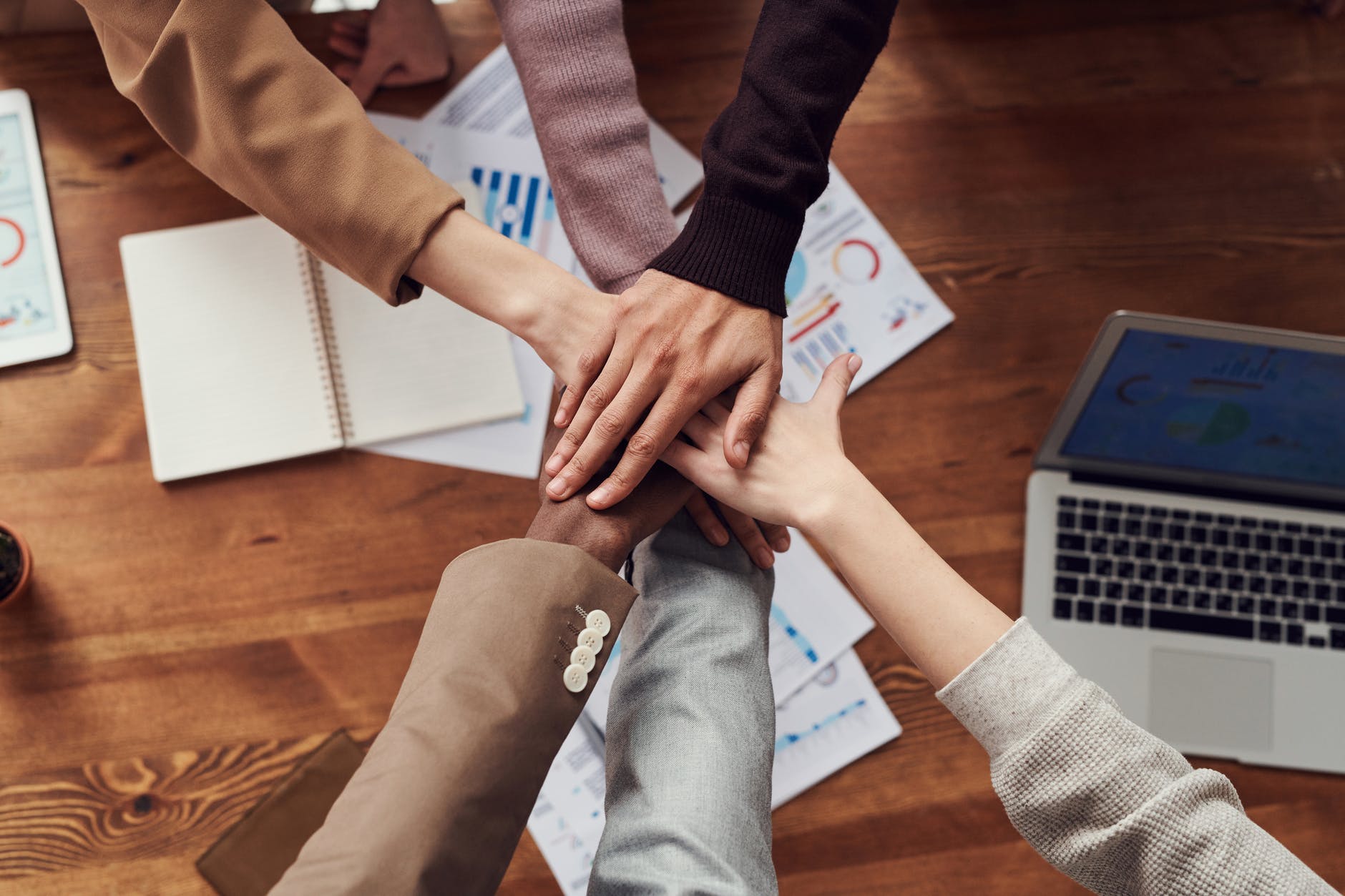 photo of people near wooden table. How to recover loss in the share market. How to recover loss from intraday trading, recover stock market loss